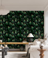 Living room sofa placed against dark green palm leaf pattern wallpaper.