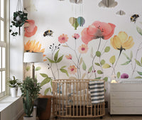 Petal parade wall mural with soft watercolor floral patterns in kids room.
