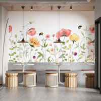 Petal parade wall mural with gentle watercolor flower tones in cafe area.