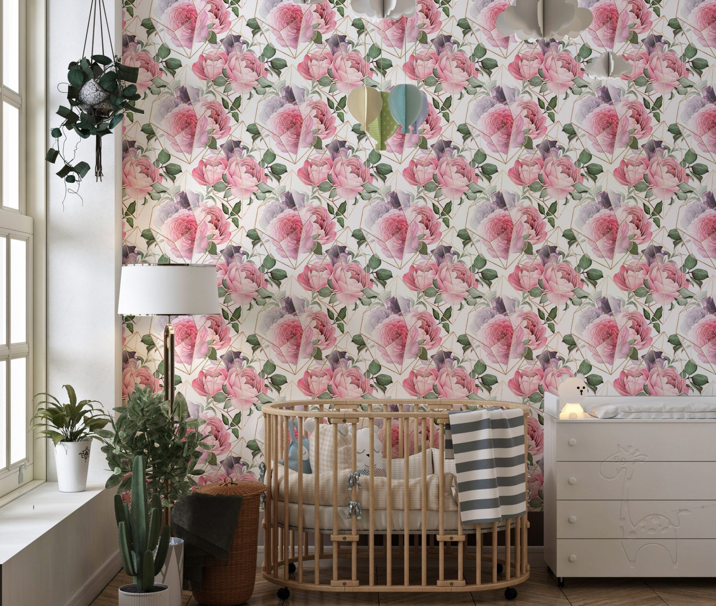 Nursery room featuring pink flower wallpaper and wooden crib.