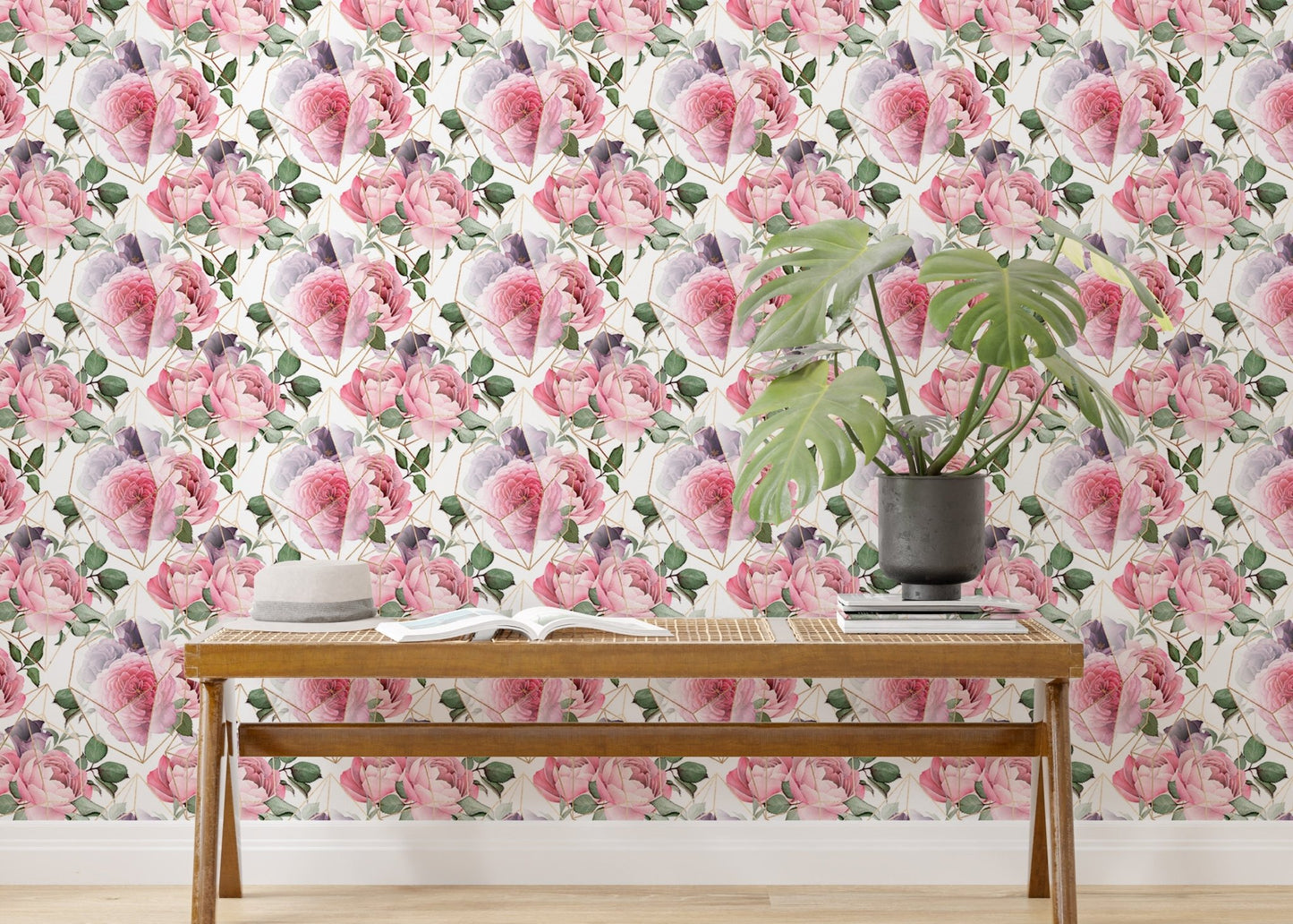Watercolor pink flower wallpaper behind wooden bench and monstera plant.