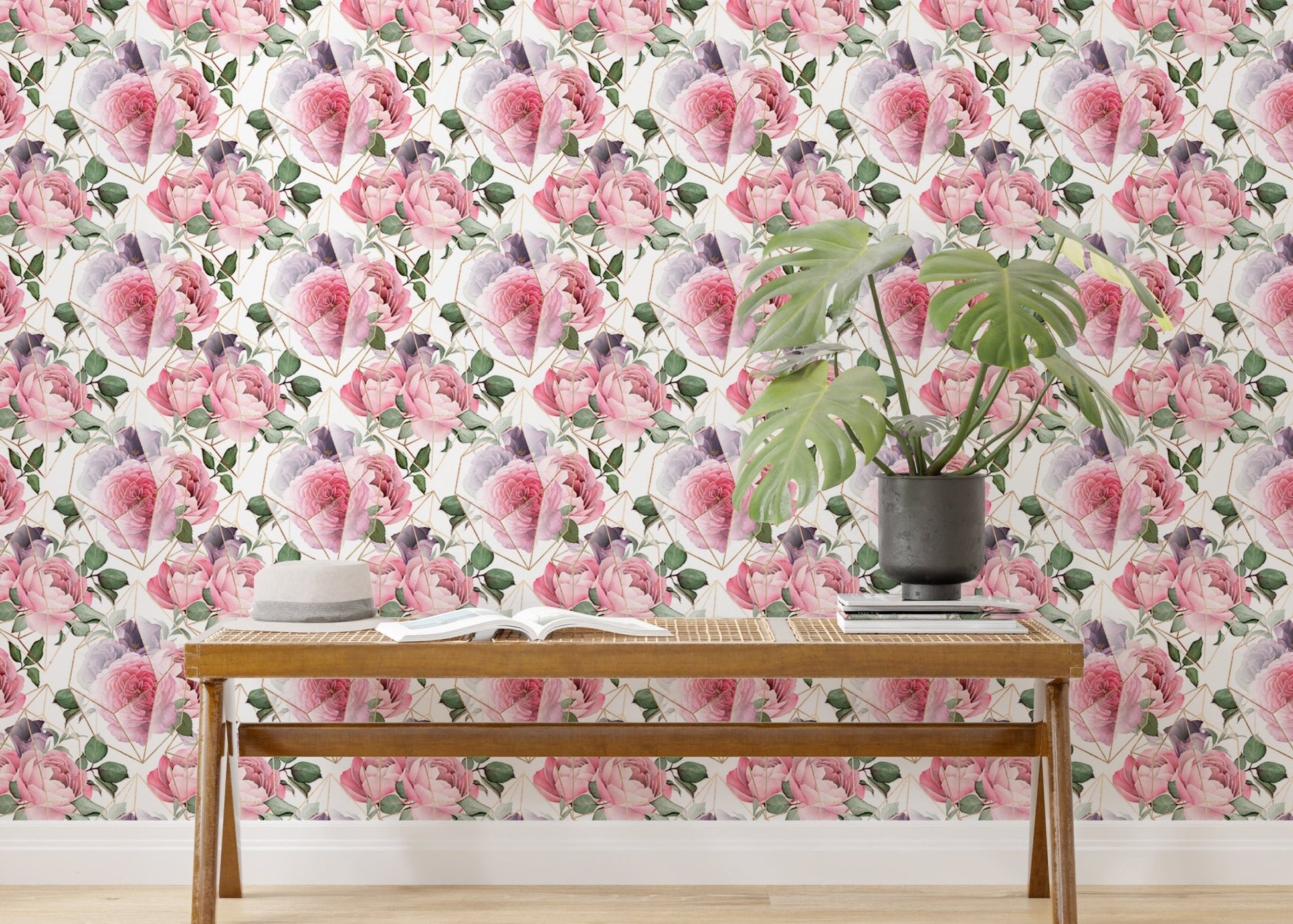 Watercolor pink flower wallpaper behind wooden bench and monstera plant.
