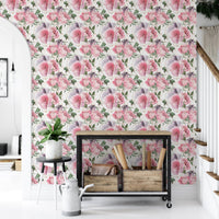 Entryway wallpaper with pink flowers and a black metal storage rack.