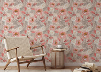 Pink roses wallpaper in a minimalist sitting area with a wooden chair and side table.