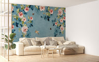 Airy living space including a cream sofa and blue botanical wall mural.