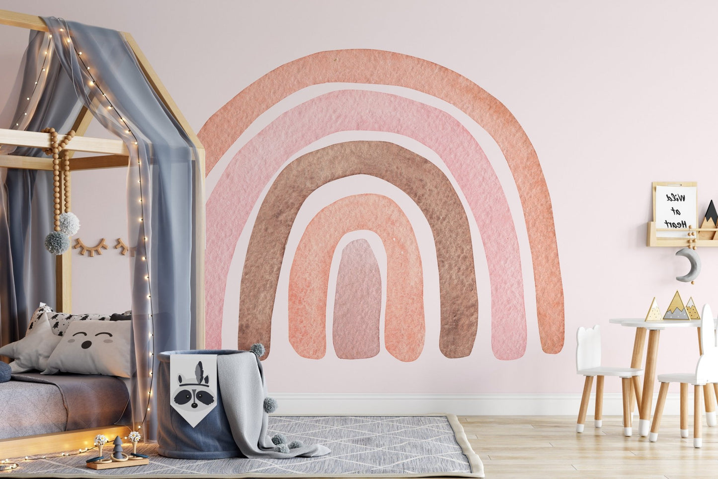 Modern kids room wall mural with pink rainbow and a grey house-shaped bed.