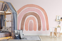 Modern kids room wall mural with pink rainbow and a grey house-shaped bed.