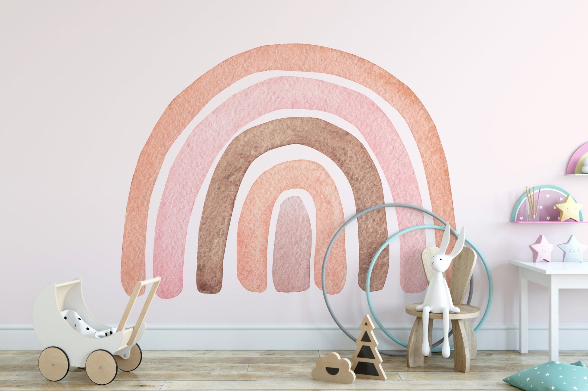 Nursery wall with watercolor rainbow mural and wooden floor toys.