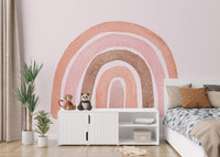 Terracotta and pink watercolor rainbow wall mural in a brightly lit bedroom.