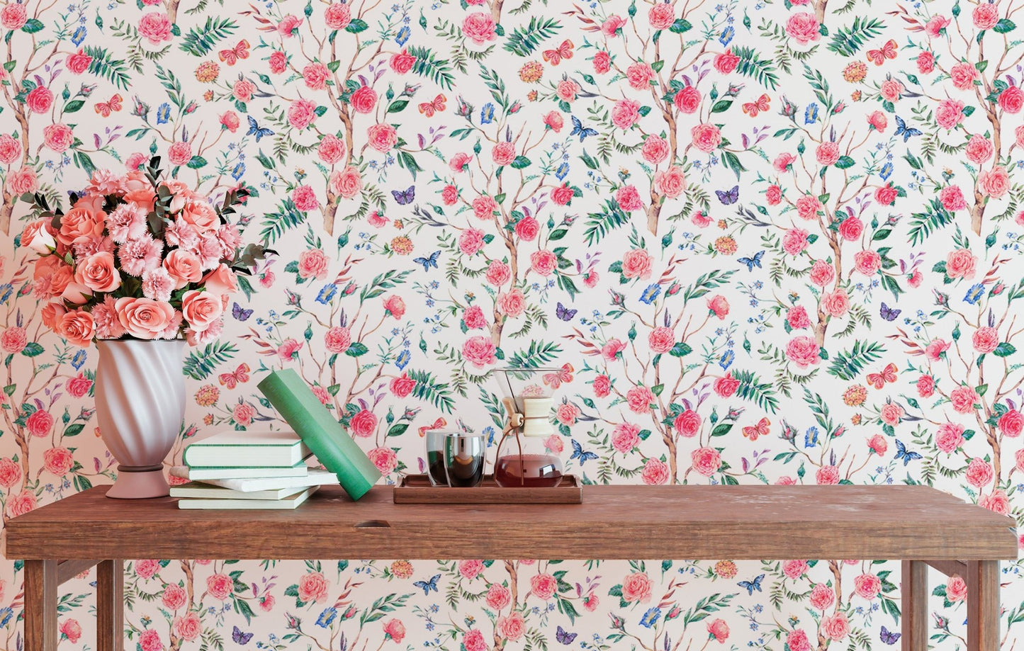 Multi-colored floral wallpaper in a study with a small wooden desk and vase.