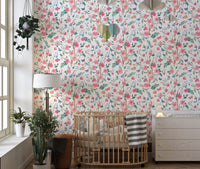 Botanical rose wallpaper in a nursery with a wooden crib and window light.