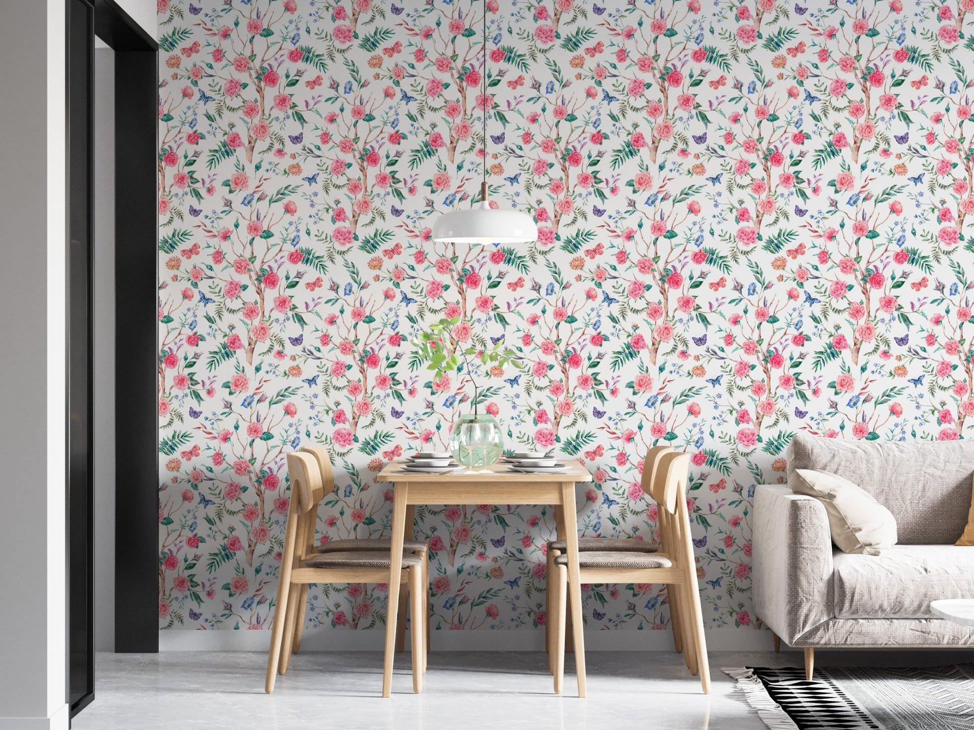 Botanical rose wallpaper in an open plan apartment with wooden dining furniture.