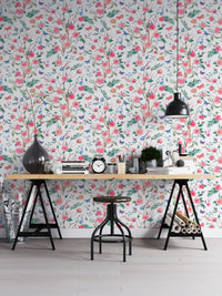 Detailed rose wallpaper in a creative studio with a large industrial desk.