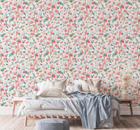 Pink rose bouquet wallpaper in a bedroom with a tan throw blanket.