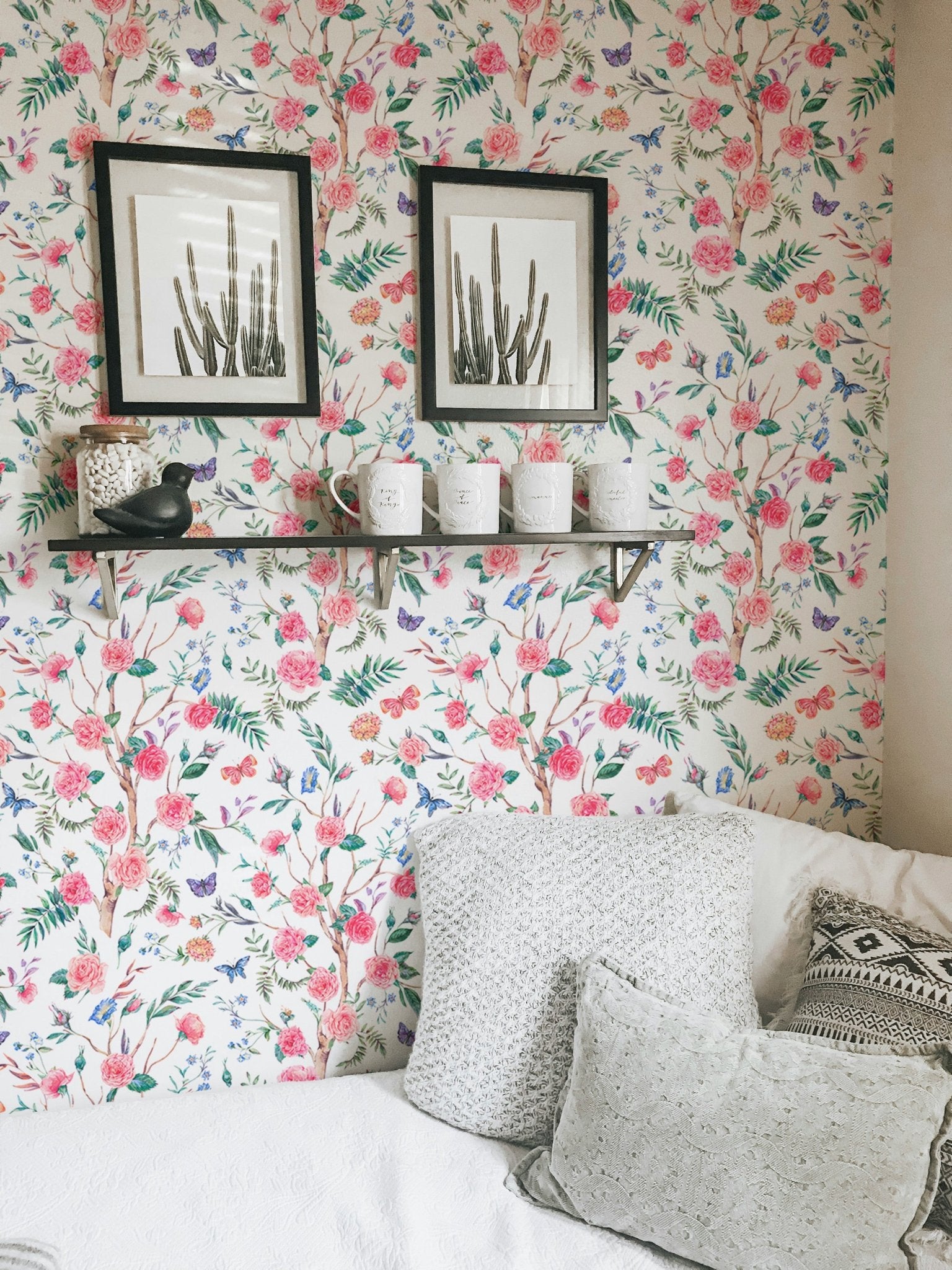 Watercolor Rose Bouquet Blooming White Floral Wallpaper behind a shelf with frames.