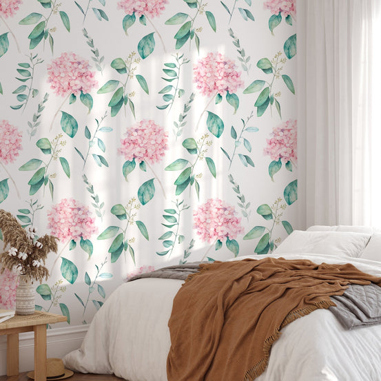 Pink flower wallpaper in a sunlit bedroom with a brown throw blanket.