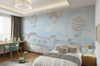 Pastel colored hot air balloons in a light blue sky wall mural for child's bedroom.