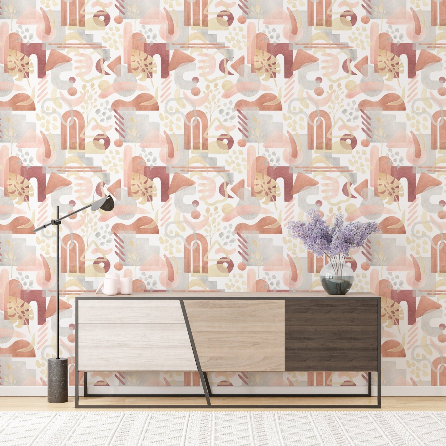 Modern sideboard placed against watercolor warm pastel colors wallpaper.