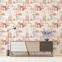 Modern sideboard placed against watercolor warm pastel colors wallpaper.