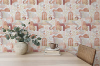 Dining area featuring a vase of flowers and warm pastel boho wallpaper.