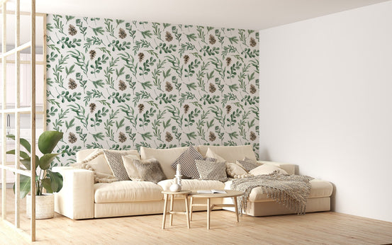Green botanical wallpaper in a living room with a beige sofa and wooden floor.