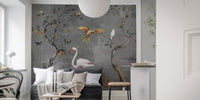 Grey fables wall mural featuring white flamingos and golden birds behind a grey sofa in living room.