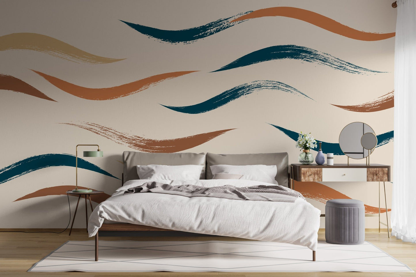 Grey bed set against a beige wall mural with abstract wave patterns.