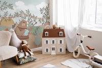 Storybook animal band wallpaper mural with soft blue sky background.