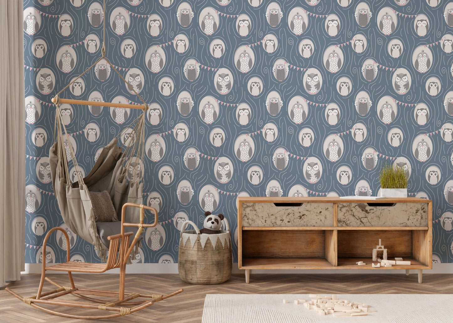 Minimalist nursery wallpaper with blue owl pattern and light wood rocking chair.