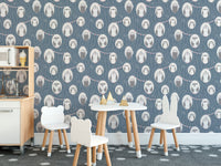 Nursery wallpaper with owl illustrations behind a small white table and chairs set.
