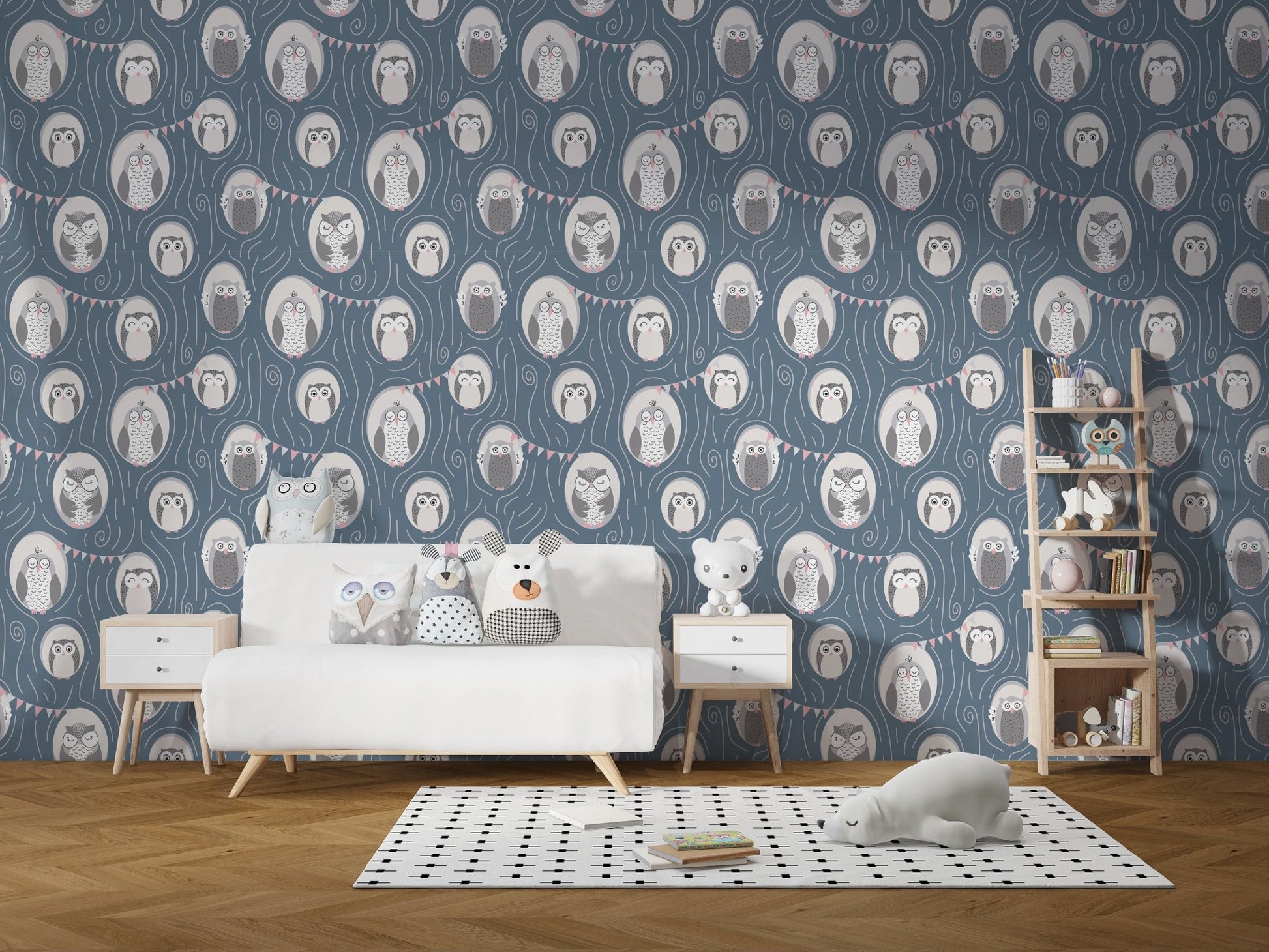 Kids' play area featuring owl print wallpaper and white storage cabinets with toys.