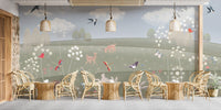 Storybook nature mural for lounge with birds, clouds and illustrated meadow plants.