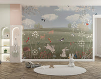 Soft pastel meadow wall mural with butterflies and woodland animals for kids room.