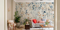 Spacious living area with white furniture and botanical meadow pattern wall mural.