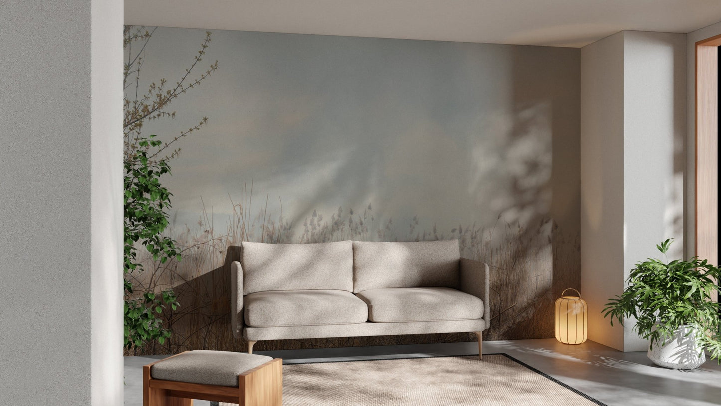 Neutral tone reeds wall mural behind a grey sofa in a sunlit living room.