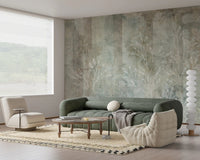 Green and beige whispers wall mural in a studio apartment with large windows.