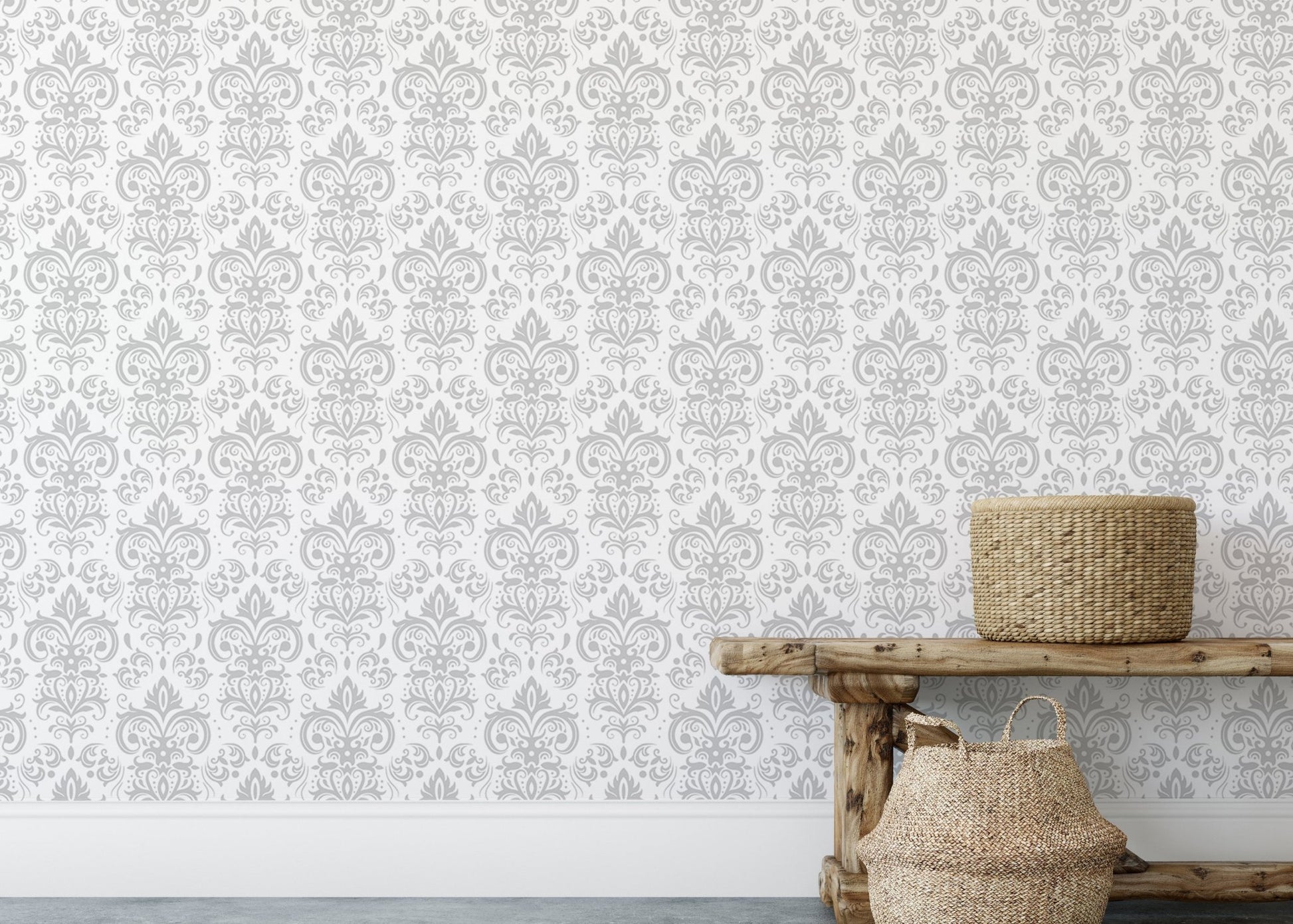 Grey damask patterned wall mural above a rustic wooden bench with woven baskets.