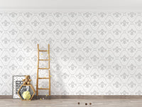 Neutral vintage damask wallpaper in a child's room with a wooden ladder.