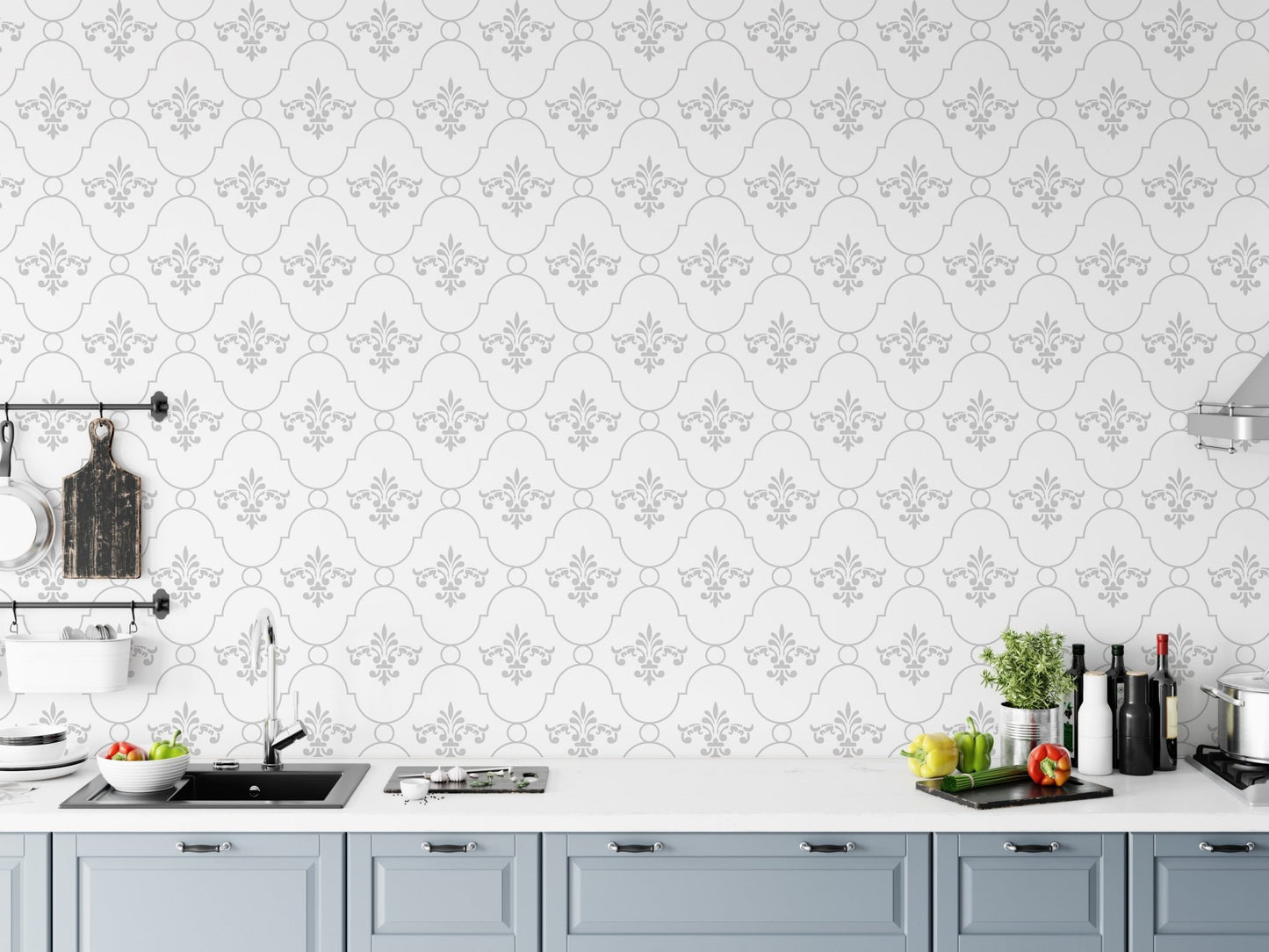 Patterned wallpaper in a kitchen setting above a grey countertop and cabinets.