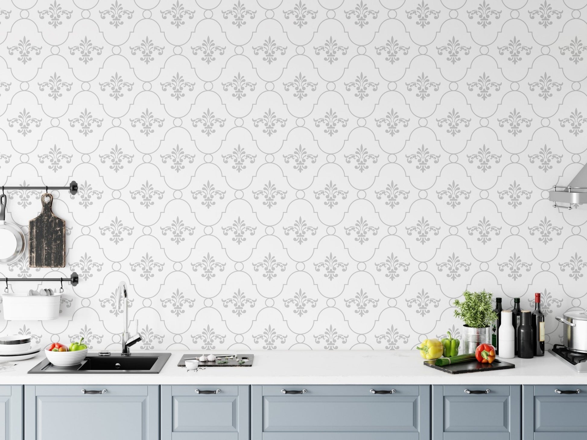 Patterned wallpaper in a kitchen setting above a grey countertop and cabinets.