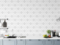 Patterned wallpaper in a kitchen setting above a grey countertop and cabinets.