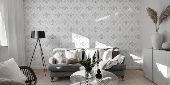 Repeating vintage pattern wallpaper behind a grey sofa and black floor lamp.