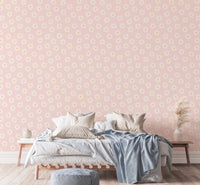 White Cosmos Flower Pink Background Wallpaper in a bedroom with blue bedding.
