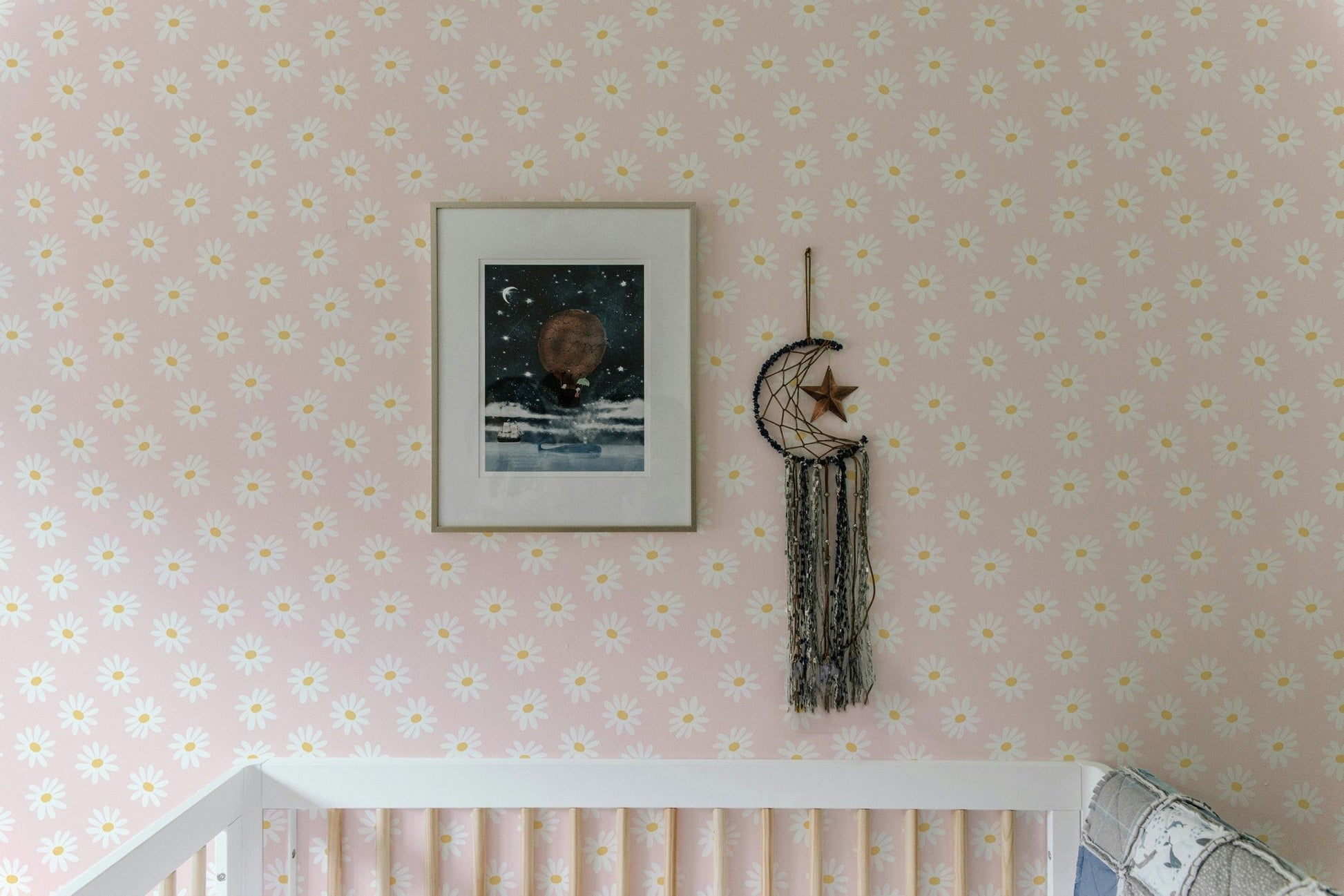 Pink wallpaper with white petal pattern in a bright kids bedroom interior.