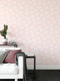 Living room corner with a white sofa and pink flower pattern wallpaper.