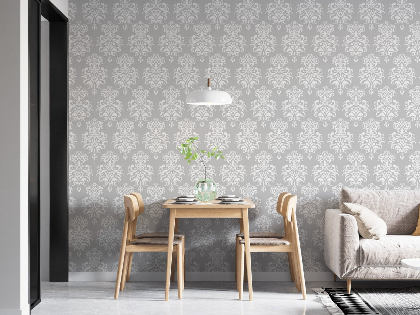 White damask wallpaper in a modern dining room with a grey sofa.