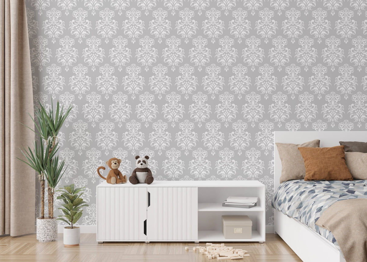 White color damask pattern wallpaper in a kids bedroom with white cabinets.