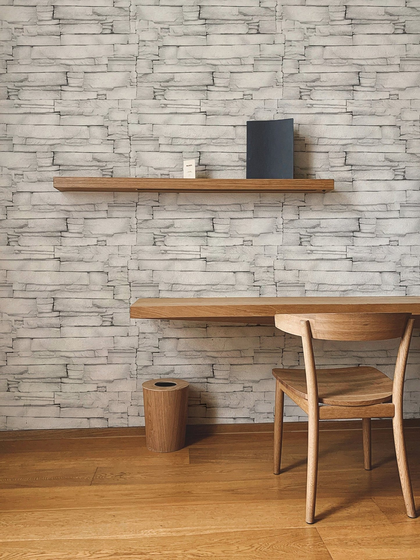 Realistic white stone pattern wallpaper used as a backdrop for a study area.
