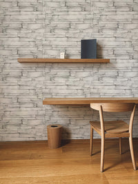 Realistic white stone pattern wallpaper used as a backdrop for a study area.
