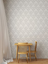 Damask pattern wallpaper in a children's dining area with a small wooden table.